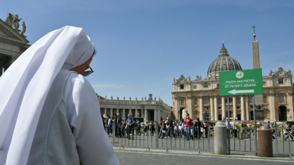 Stunned and sad, faithful gather at St Peter's to remember Francis
