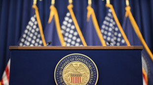 Stocks diverge, dollar down as Fed meets on rates