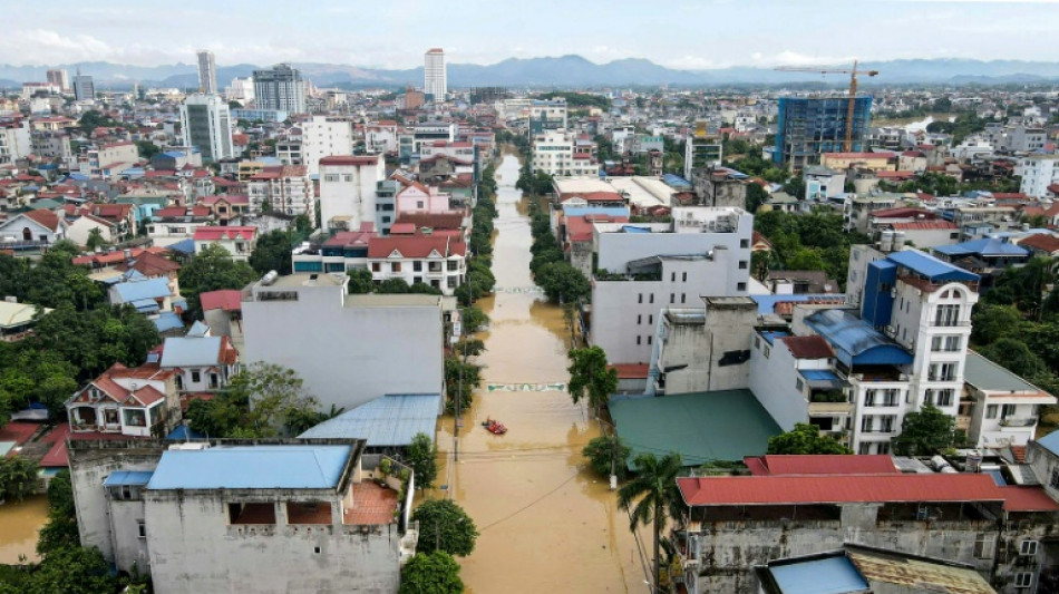 Record flooding hits Vietnam city, eight killed in north